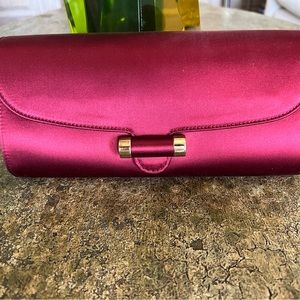 Yves Saint Laurent Muse Clutch in red satin with gold hardware. Never been worn.